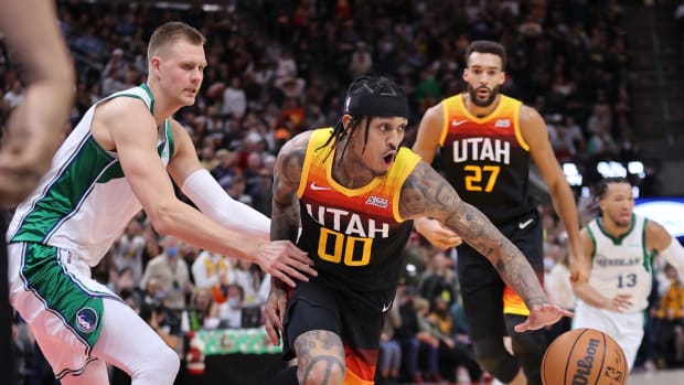 Dec 25, 2021; Salt Lake City, Utah, USA; Dallas Mavericks center Kristaps Porzingis (6) and Utah Jazz guard Jordan Clarkson (00) play for a loose ball in the fourth quarter at Vivint Arena. Mandatory Credit: Rob Gray-USA TODAY Sports
